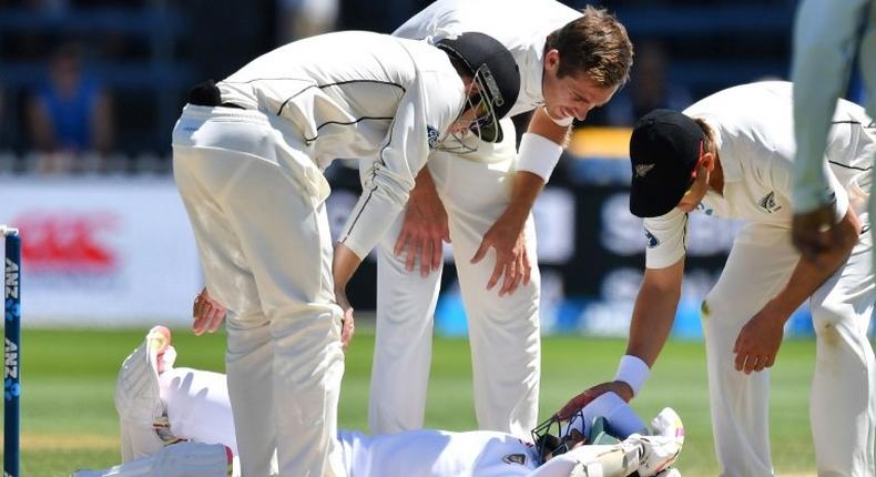 Bangladesh's Mushfiqur Rahim is checked by New Zealand's Tom Latham (L), Tim Southee (C) and Neil Wagner after Rahim was hit in the head during their first Test match, in Wellington, on January 16, 2017