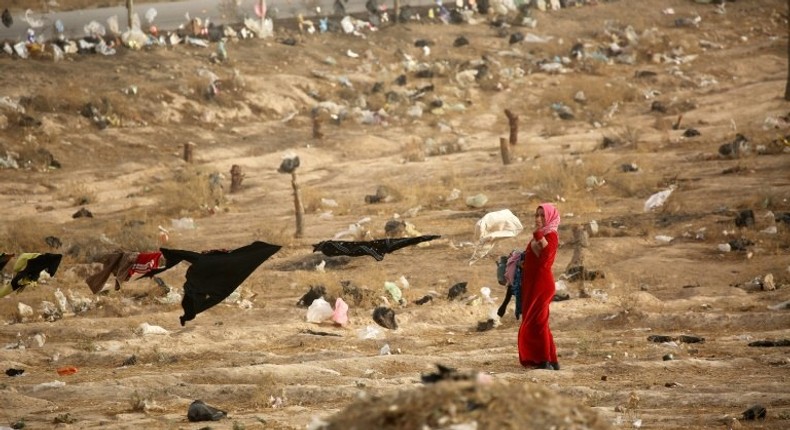 An Iraqi refugee from Mosul hangs up laundry at the UN-run al-Hol refugee camp in Syria's Hasakeh province, on October 31, 2016