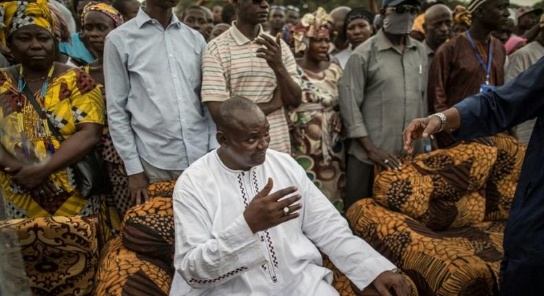 Adama Barrow, the flag-bearer of the coalition of the seven opposition political parties in Gambia, gestures while greeting supporters during a gathering on November 29, 2016