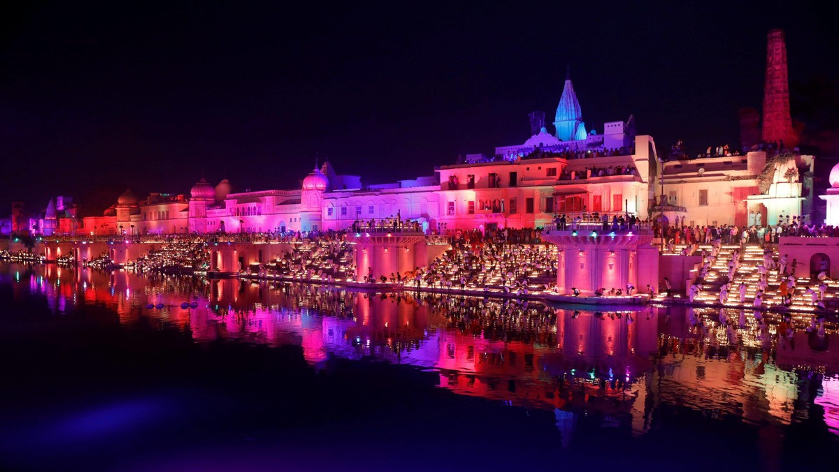 Participants light earthen oil lamps on the banks of the Sarayu river in an attempt to enter the Gui