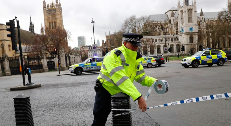 A police officer taping off Parliament Square after reports of loud bangs in London on Wednesday.