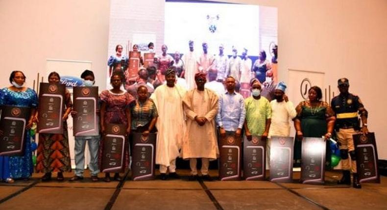 L-R: Lagos State Governor, Mr Babajide Sanwo-Olu (6th right) flanked by Head of Service, Mr Hakeem Muri-Okunola (6th left) in a group photograph with winners of car gift at the Luncheon with 2019/2020 outstanding officers (Junior & Senior Categories) in the Public service at the Marriott Hotel, Ikeja, on Tuesday, July 6, 2021. [NAN]