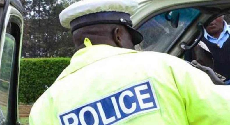 A traffic police officer inspects a matatu. Police boss Hillary Mutyambai orders arrest of passengers carried as excess in PSVs