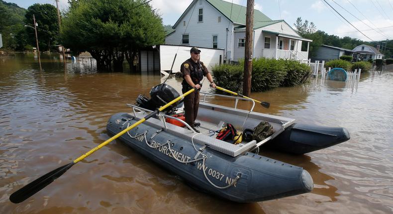 Lt. Dennis Feazell, of the West Virginia Department of Natural Resources, rows his boat as he and a co worker search flooded homes after floods hit the state in June 2016 (file photo).