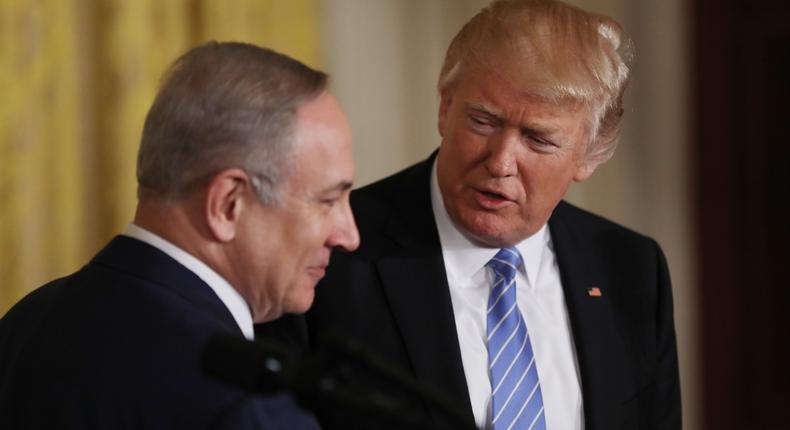 US President Donald Trump (R) looks to Israeli Prime Minister Benjamin Netanyahu hold a joint news conference at the White House in Washington, U.S., February 15, 2017.