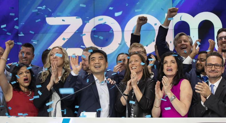 Zoom CEO Eric Yuan, center, celebrates the opening bell at Nasdaq as his company holds its IPO, Thursday, April 18, 2019, in New York. The videoconferencing company is headquartered in San Jose, Calif. (AP Photo/Mark Lennihan)