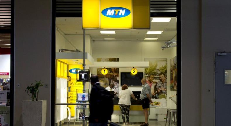 Travellers walk past an MTN telecom shop at King Shaka International Airport in Durban, South Africa, November 16, 2015.   REUTERS/Rogan Ward