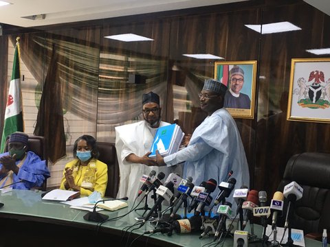 Prof. Mahmood Yakubu (right) hands over to the retired Air Vice Marshal Ahmed Mu'azu (left) [INEC]