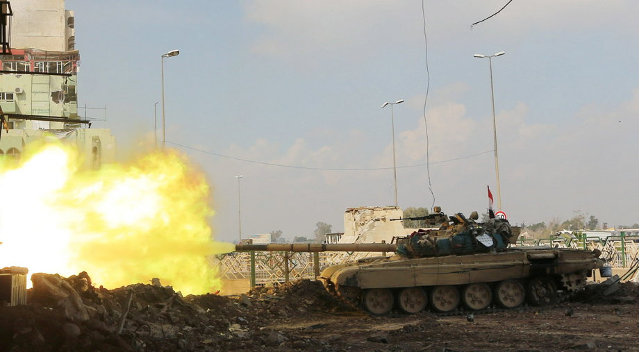 A Iraqi rapid-response forces tank fires against ISIS militants in the Bab al-Tob area of Mosul, Iraq, March 14, 2017.