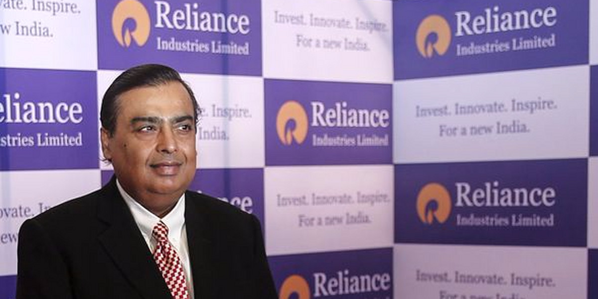 Mukesh Ambani, chairman of Reliance Industries Limited, poses for photographers before addressing the annual shareholders meeting in Mumbai