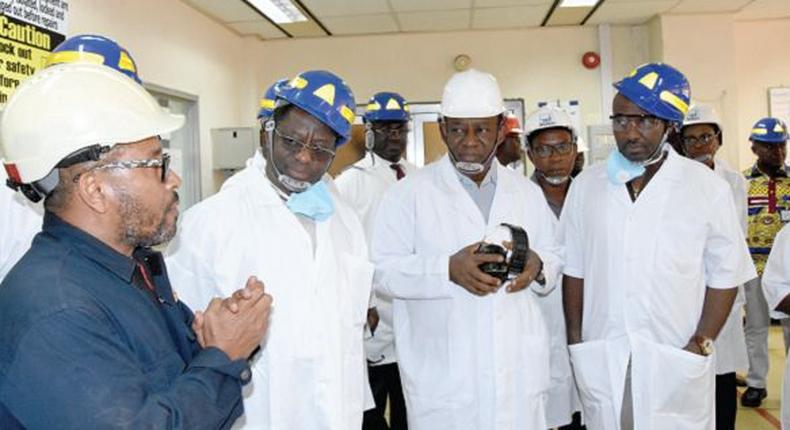 John Peter Amewu (2nd left), the Minister of Energy, and Isaac Osei (2nd right), the MD, Tema Oil Refinery, being briefed on the operations of the refinery during the tour.