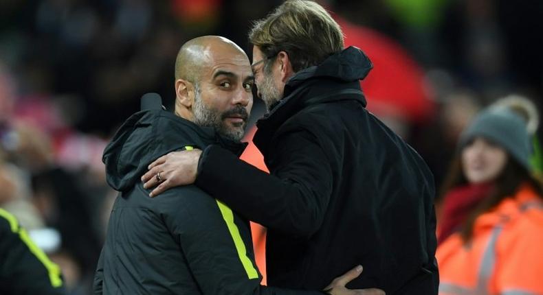 Liverpool's manager Jurgen Klopp (R) greets Manchester City's manager Pep Guardiola ahead of the English Premier League football match between Liverpool and Manchester City at Anfield in Liverpool, north west England on December 31, 2016