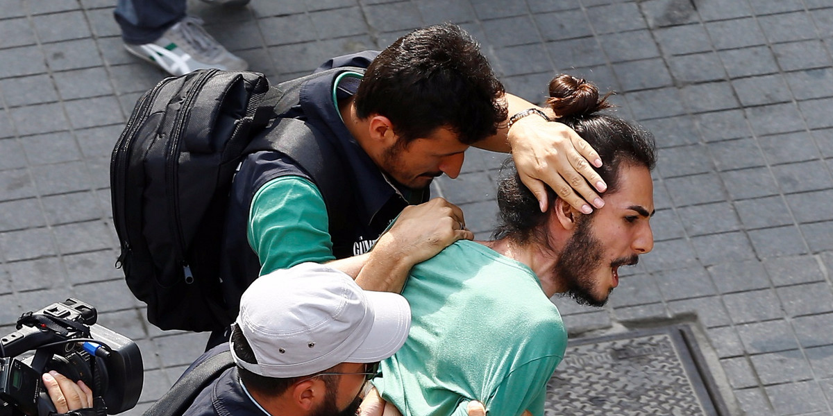 Plainclothes police officers detaining LGBT rights activists who tried to gather for a pride parade, which was banned by the governorship, in Istanbul on Sunday.
