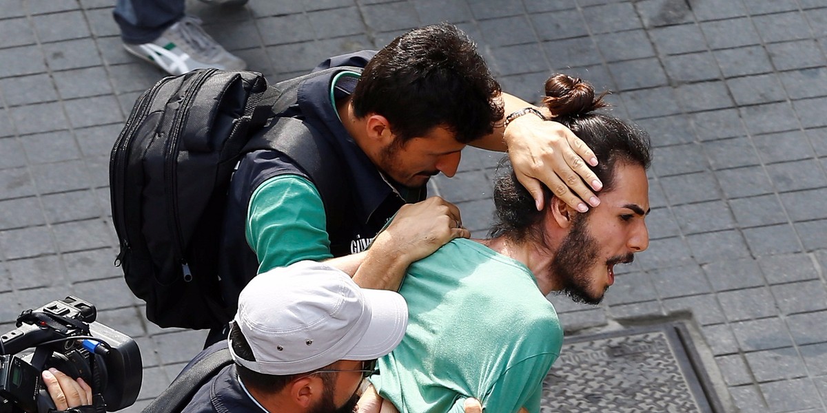 Plainclothes police officers detaining LGBT rights activists who tried to gather for a pride parade, which was banned by the governorship, in Istanbul on Sunday.