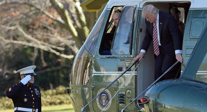 President Donald Trump walks off of Marine One on the South Lawn of the White House in Washington, Thursday, Jan. 26, 2017, after returning from a trip to Philadelphia.