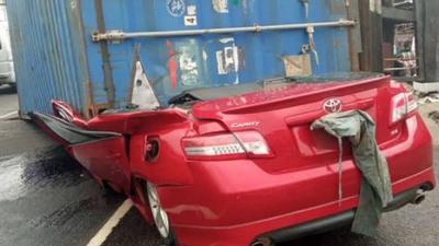 Truck carrying 40ft container falls on car in Lagos