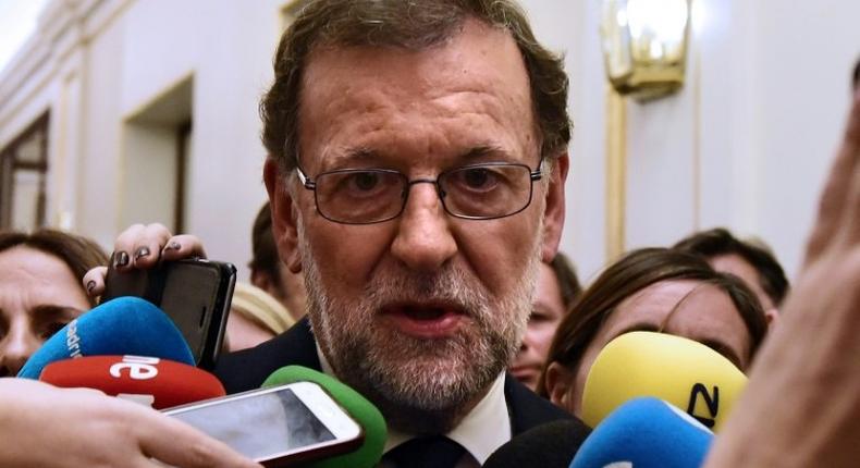 Mariano Rajoy speaks to journalists after being re-elected during the parliamentary investiture vote for a prime minister, at the Spanish Congress (Las Cortes) on October 29, 2016, in Madrid