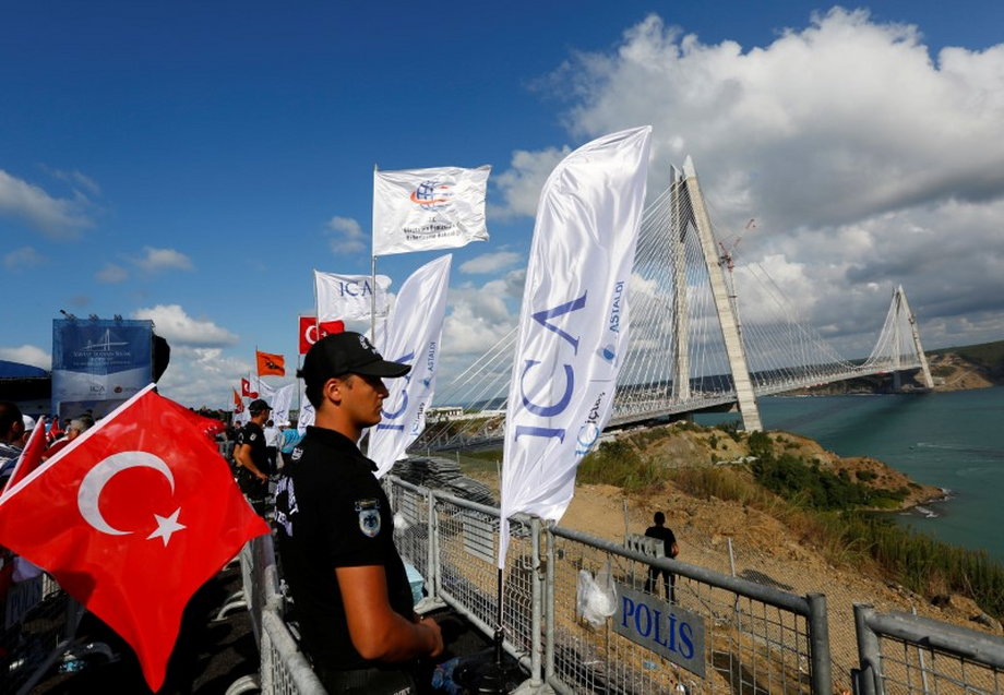 A riot police stands guard during the opening ceremony of newly built Yavuz Sultan Selim bridge, the third bridge over the Bosphorus linking the city's European and Asian sides in Istanbul