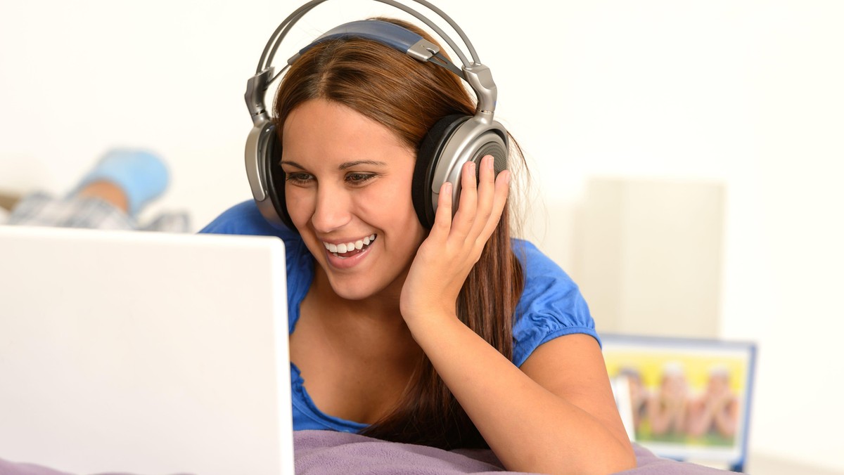 activity,adolescence,bed,bedroom,caucasian,cheerful,computer,enjoying,entertainment,fun,funny,girl,happy,headphones,indoor,internet,laptop,laughing,leisure,lifestyle,listening,lying,movie,music,relaxing,studying,surfing,teenager,using,watching,woman,young