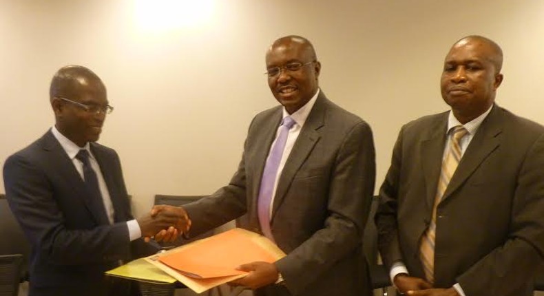 Henry Kerali, World Bank Country Director for Ghana  exchanging signed agreement with  Patrick Awuah, President of Ashesi, looking on is Mr Fredua Agyeman, Director of Environment, Ministry of Environment, Science, Technology and Innovation Climate