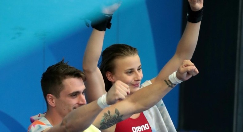 France's Laura Marino and France's Matthieu Rosset react after winning the 3m/10m team event during the diving competition at the 2017 FINA World Championships in Budapest, on July 18, 2017