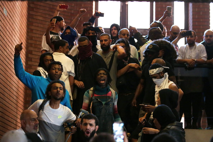 Demonstrators confront a man they believe to be Robert Black, the Chief Executive of KCTMO, outside 