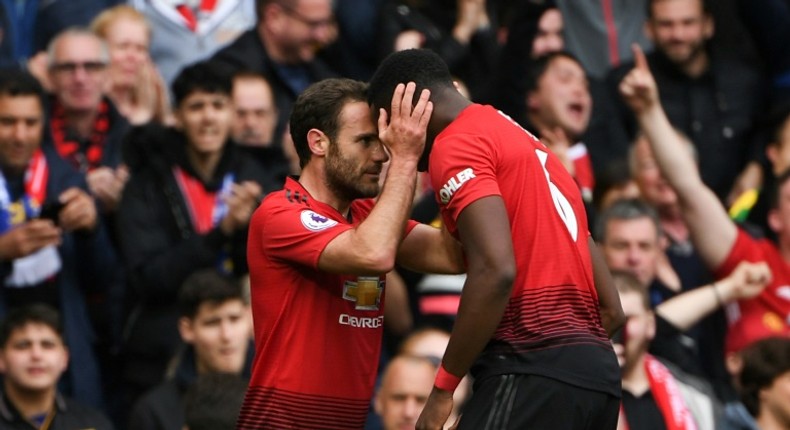 Positive Pogba: Juan Mata (left) believes Paul Pogba (right) remains a positive influence for Manchester United