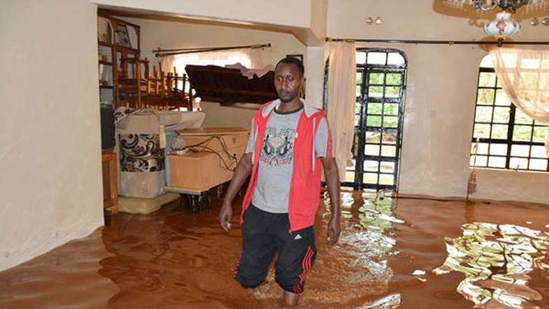 A resident standing inside a flooded home