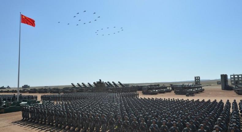 Chinese military helicopters fly in formation to make the number 90 during the parade