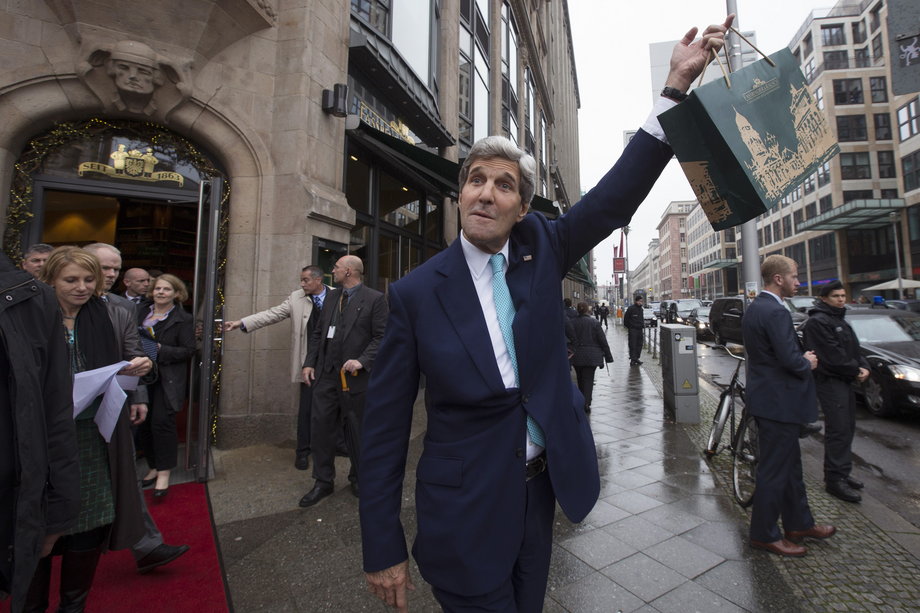 GERMANY: Kerry waves a bag of chocolates he bought at the Fassbender and Rausch store in Berlin, October 22, 2014.