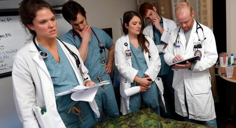 In a Friday, May 6, 2016 photo, LSU medical student Felicia Venable, left, briefs fellow students and medical residents on a patient they are visiting during daily rounds with a group of medical residents and medical students at Our Lady of the Lake Regional Medical Center in Baton Rouge, La.