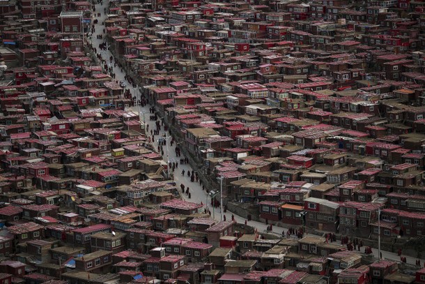 Monks and nuns walk between their dormitories after attending a daily chanting session during the Ut