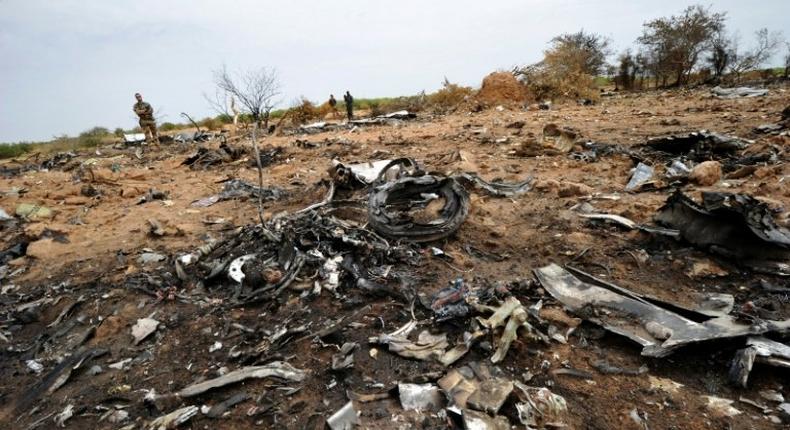 A French soldier looks at debris of the Air Algerie Flight AH 5017 in Mali's Gossi region, west of Gao on July 26, 2014