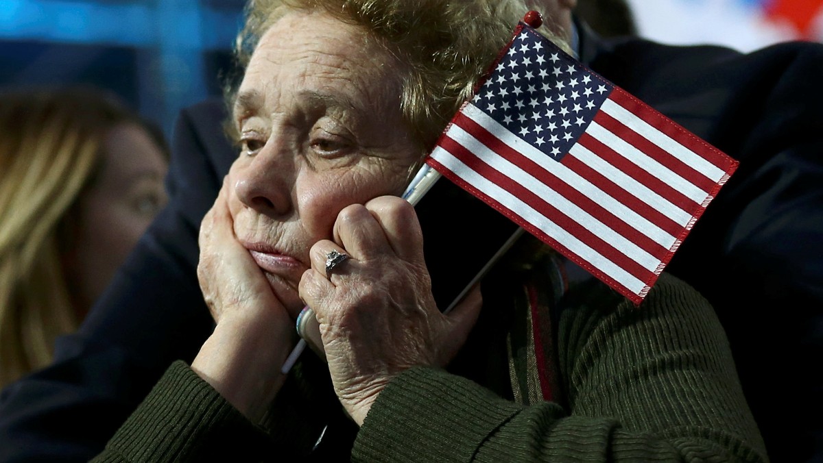 Supporter of Democratic presidential nominee Hillary Clinton watches and waits at her rally in New York