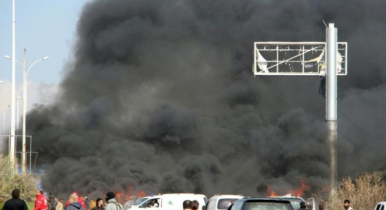 Smoke billows from the site of a suicide car bombing in Rashidin, west of Aleppo, that targeted buses carrying Syrian evacuees on April 15, 2017