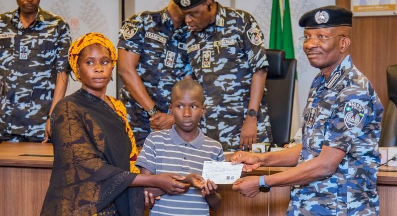 Egbetokun presents ₦535.6m cheques to families of deceased officers. [Twitter:@PoliceNG]