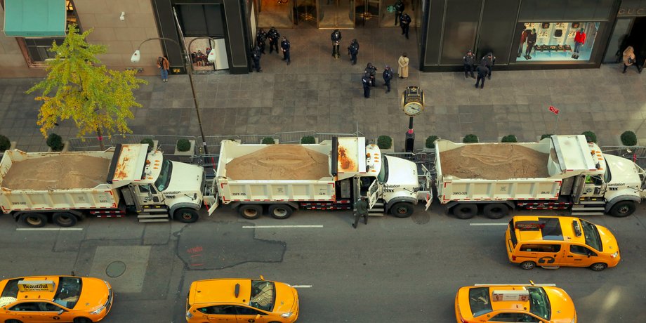 Sanitation trucks filled with sand acting as barricades along Fifth Avenue outside Trump Tower in New York City on November 8.