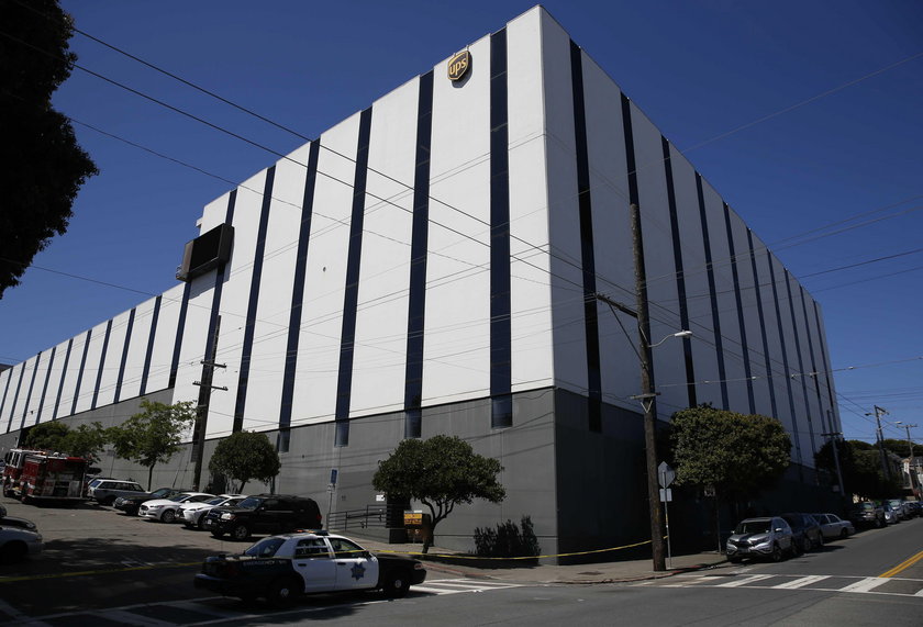 United Parcel Service vans are seen parked outside a UPS facility after a shooting incident was repo