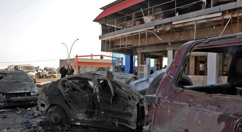 Wrecked vehicles line the street outside the Abu Layla restaurant in Iraq's Mosul on November 9, 2018, after three people were killed in the first car bombing to hit the second city since its recapture from the Islamic State group in July last year