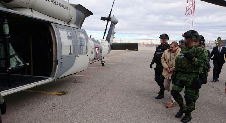 Mexican drug lord Joaquin El Chapo Guzman escorted by soldiers in Ciudad Juarez, Mexico, as he is extradited to New York, January 19, 2017.