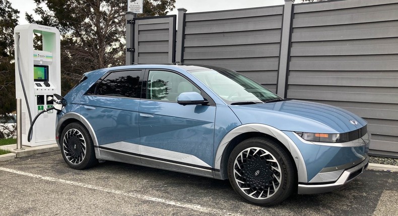 The 2022 Hyundai Ioniq 5 charges at an Electrify America fast charging station.