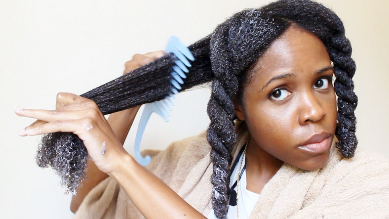 Detangling hair extensions with wide tooth comb 