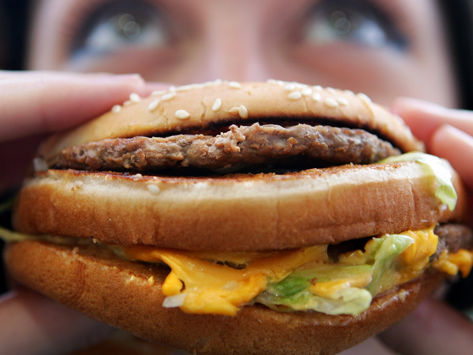 In this photo illustration a lady eats a beefburger on July 12, 2007 in London, England. Government advisors are considering plans for a fat tax on foods high in fat to try to help tackle the fight against obesity.