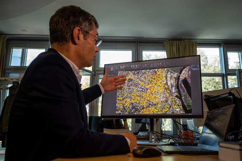 Manuel Fayol of the United Nations Satellite Center (UNOSAT) points out during a joint press presentation by UNESCO and UNOSAT about a new platform that will record and monitor the destruction of cultural objects in Ukraine