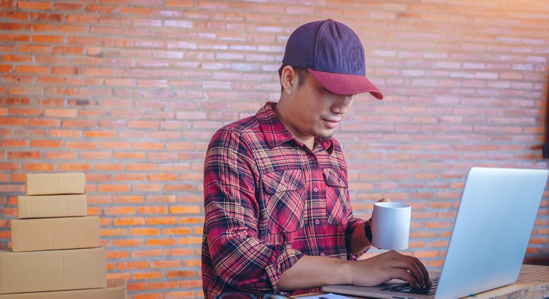 Man working in open office answering emails