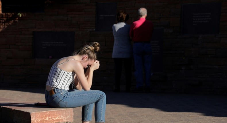 Maren Strother, 16, rests her head on her hands at a vigil in Littleton, Colorado to the April 20, 1999 mass shooting at Columbine High School