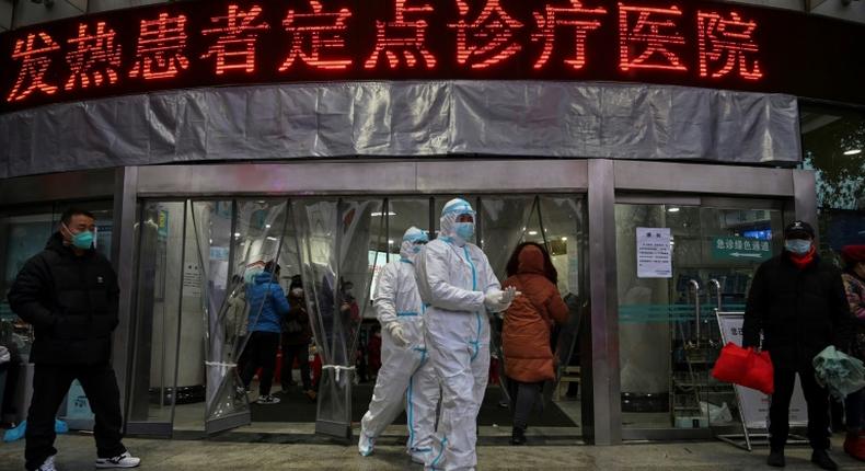 Medical staff outside  the Wuhan Red Cross Hospital, where resources are stretched to the limit