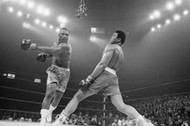 Muhammad Ali cofa się po ciosie Joe Fraziera podczas walki o tytuł mistrza wagi ciężkiej w Madison Square Garden w 1971 r. Po piętnastu rundach jednogłośną decyzją sędziów zwyciężył Frazier.