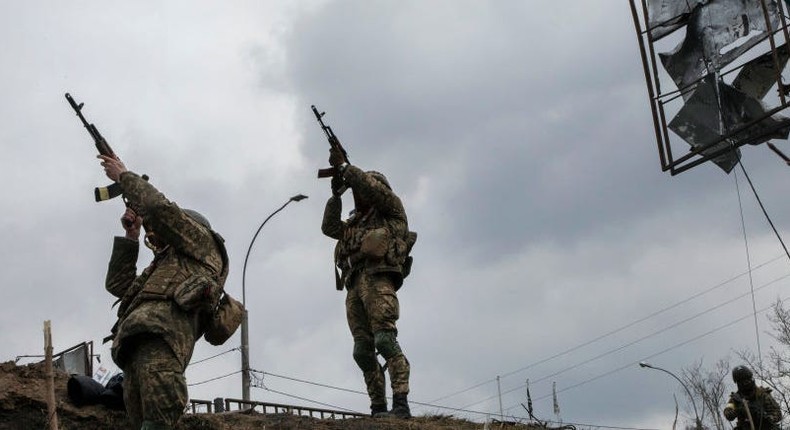 Ukrainian soldiers on the collapsed bridge that crosses the Irpin River aim for a suspected Russian observation drone on March 6, 2022 in Irpin, Ukraine.