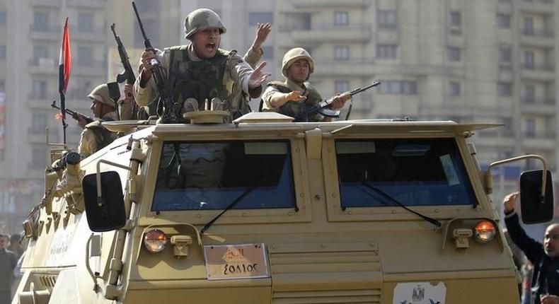 Army soldiers take their positions with their armoured personnel vehicle in the Cairo suburb of Matariya November 28, 2014. REUTERS/Mohamed Abd El Ghany